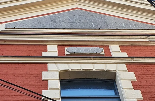 conservatory pediment with the words Maison des vieillards (Old People's Home)